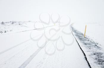 Empty rural road covered with snow in cold winter season, Reykjavik district, Iceland