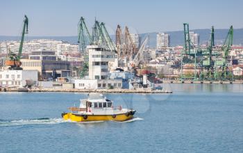 Yellow and white pilot boat enters the port of Varna, Black Sea port, Bulgaria