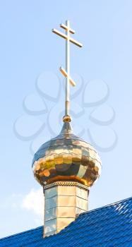 Golden dome with cross of small Orthodox church in St.Petersburg, Russia