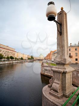Stone street-lamp on the old Pikalov bridge in center of Saint-Petersburg, Russia