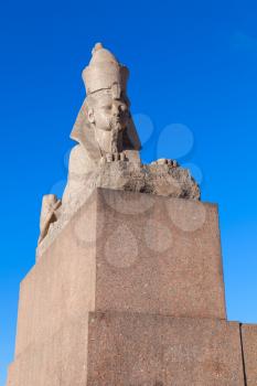 Granite sphinx ancient monument on blue sky background. Landmark of Neva river coast in St.Petersburg, Russia