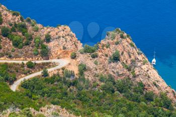 Coastal landscape of Corsica island. Mountain road on Capo Rosso, Piana region