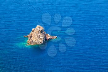 Small rocky island in Mediterranean sea near coast of Corsica, France