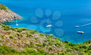 Coastal summer landscape of South Corsica, pleasure yachts moored in azure bay