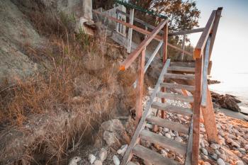 Perspective view of wooden stairs on the beach. Coast of Zakynthos island, Greece