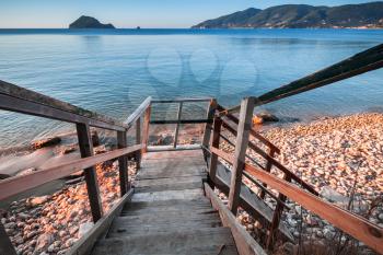 Perspective view of wooden stairs going to beach. Coast of Zakynthos island, Greece