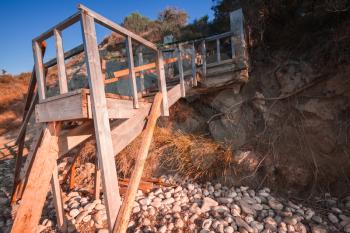 Old wooden stairs going to the beach. Coast of Zakynthos island, Greece
