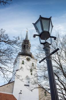 Tallinn old town, street light with tall church on a background