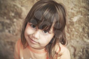 Skeptical Caucasian little girl, close up face portrait