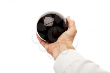 Male hand holds black glossy plastic sphere. Close-up photo isolated on white