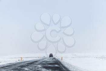Icelandic road covered with snow, winter landscape of Iceland, travel theme