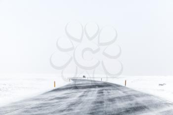 Icelandic road covered with snow, empty winter landscape. Iceland