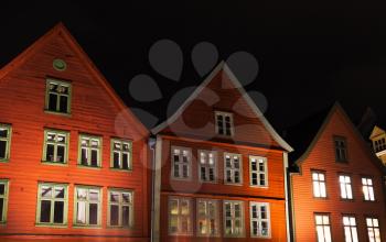 Traditional Norwegian red wooden houses at night, Bergen Bryggen                                     