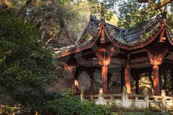 Traditional Chinese wooden gazebo pavilion on the coast of West Lake, popular public park of Hangzhou city, China