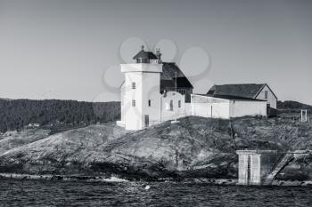 Terningen Lighthouse black and white retro stylized photo. Coastal lighthouse located in Hitra Municipality, Trondelag county, Norway