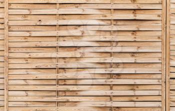 Uncolored wicker wall made of pine wood boards, flat background photo texture