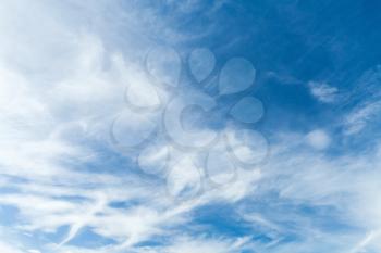 Blue sky with white cirrus clouds at day. Natural background photo texture