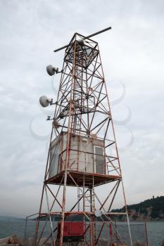 Radar and communication station tower under cloudy sky