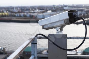 Closed-circuit television camera mounted on a rooftop of a port building in Hamburg harbor, Germany