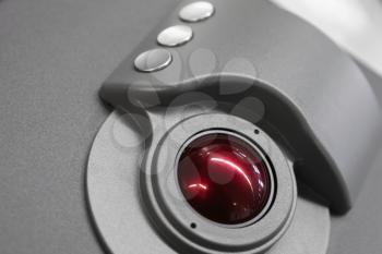 Industrial control panel made of gray metal with red trackball, close up photo with soft selective focus