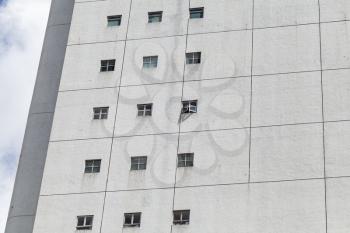 Abstract fragment of modern industrial  architecture, white wall with square windows