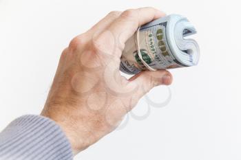 Roll of One Hundred Dollars in male hand isolated on white background
