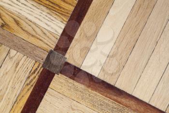 Classical wooden parquet with geometric pattern, decorative tiling background texture