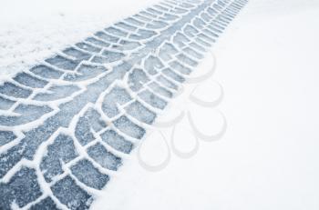 Car track on a wet snowy road, closeup background photo texture