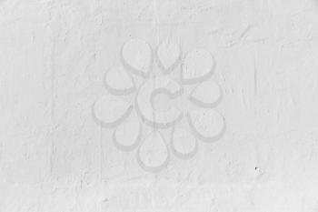 White concrete wall texture with relief paint layer pattern