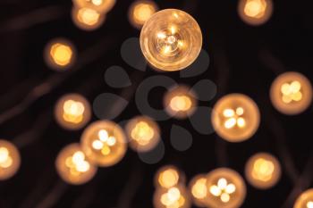 Garland of bulb lamps with modern yellow LED lighting elements, close up photo with selective focus and real photo bokeh effect
