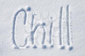 Chill. Hand drawn text over fresh snow 