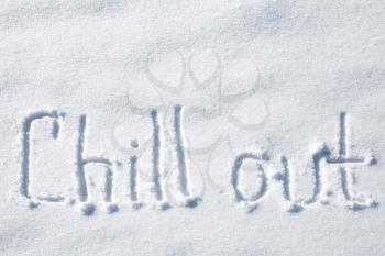Chill out. Hand drawn text over fresh snow 