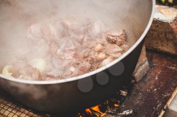 Lamb pieces with onion boiling in a cauldron. Preparing of Chorba soup, traditional meal for many national cuisines