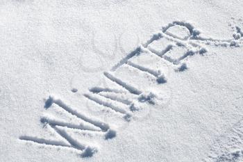 Winter. Hand drawn text on fresh snow in sunny day
