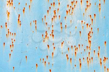Old grungy blue metal wall with rust specks, industrial background photo texture