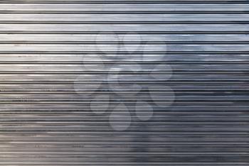 New shining corrugated metal fence, standard industrial wall, background photo texture
