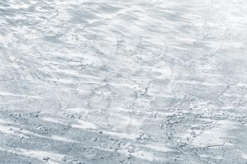 Ice surface covered with show on frozen river in winter season, natural background photo texture