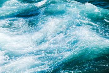 Stormy sea texture, waving deep blue water surface with foam, natural background photo