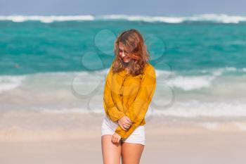 Portrait of pretty Caucasian teenage girl with red hair on the beach in Dominican Republic