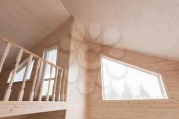 Empty new wooden house interior, hall with balcony and window