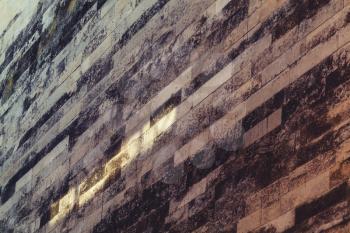 Dark stone wall with light beam, abstract background photo texture