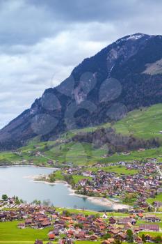 Vertical ural Swiss landscape. Lungern lake and the village on the coast