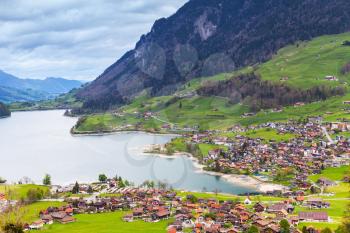 Rural Swiss landscape. Lungern lake and the village on the coast