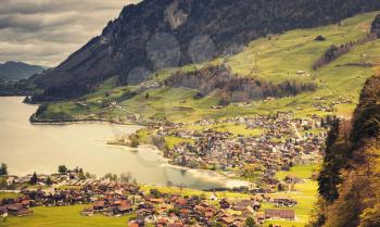 Rural Swiss landscape. Lungern village in spring time. Warm tonal correction filter effect