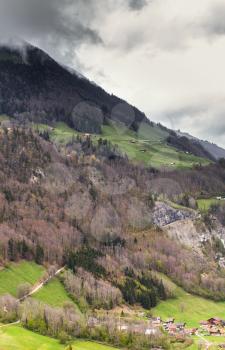 Rural Swiss landscape. Lungern village under dark cloudy sky