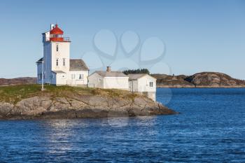 Tyrhaug, white tower with red navigational light on top. Coastal lighthouse located in Smola Municipality, More og Romsdal county, Norway. It was established in 1833