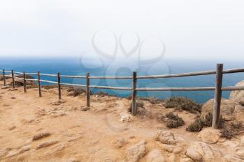 Old wooden railings on the edge of Cabo da Roca. Westernmost point Portugal and Europe