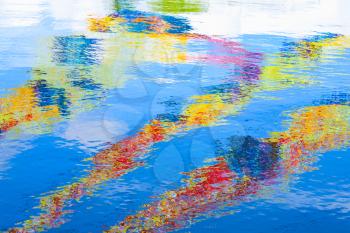 Colorful reflections over ripple water surface. Abstract background photo