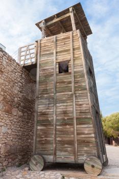 Wooden Roman Siege Tower near stone fortress wall