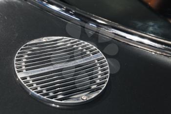 Air intake grille. Luxury vintage car fragment, close up photo with selective soft focus